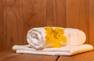 Obraz na płótnie Canvas White towels on a shelf in the bathhouse. Autumn procedures concept