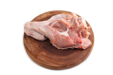 Raw turkey wing on a wooden cutting board isolated on white. Side view.