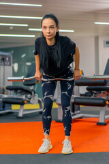 young girl in sportswear in the gym doing barbell exercises fitness training healthy beautiful body