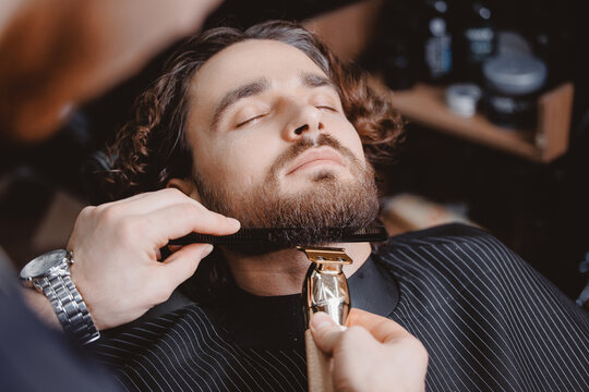 Man hipster having barber shave barbershop hair machine