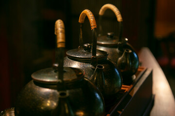 Iron tea containers in a traditional tea house in Murakami City, Japan.