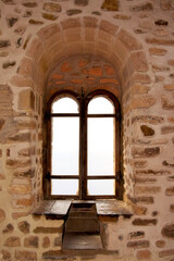 Classic old windows on a stone wall. Elements of European traditional architecture

