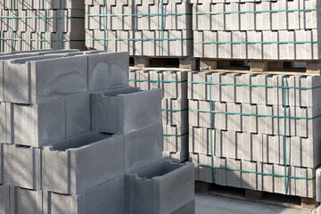 Pallet of Concrete Cinder Blocks, Grey Uniformed brick Shapes building material. New for use on construction site in europe