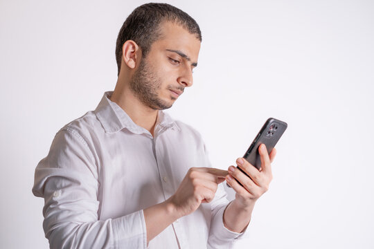 Isolated image of bearded middle eastern business man working on smartphone.