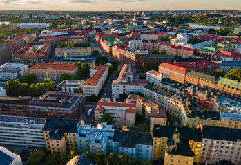Aerial close view to Helsinki central residental area. Multistory buildings. Colorful roofs in Scandinavia. Finland sunset