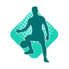 Silhouette of a male soccer player kicking a ball. Silhouette of a football player in action pose.
