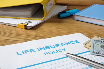 Life insurance policy, money and documents.