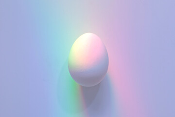 Pastel-Colored Light Reflections on White Egg. Easter Background