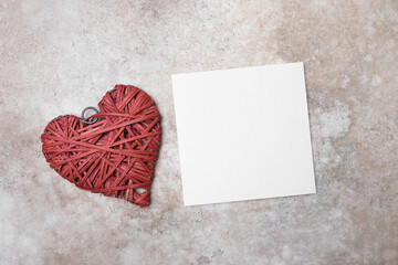 Blank square valentines card mockup with red heart, top view with copy space