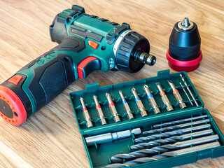 Cordless drill driver with screw bits and drill bits. Tool free changeover between drilling and...
