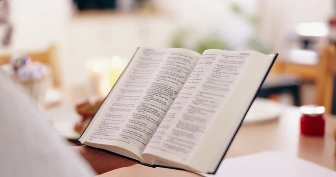 Person, bible book and closeup with hands, reading or studying for praise, worship or faith in home. Knowledge, information or religion with history, learning or spiritual guide for connection to God