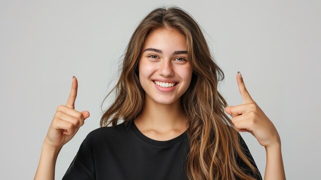 Portrait of an American woman in black t shirt indicating  two forefingers up in a clean backdrop with copy space, Generative AI.
