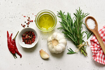 Traditional spices of mediterranean cuisine : sea salt, garlic,pepper, rosemary, sea salt and olive oil. Top view with copy space.