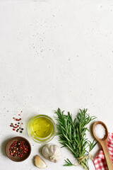 Traditional spices of mediterranean cuisine : sea salt, garlic,pepper, rosemary, sea salt and olive oil. Top view with copy space.