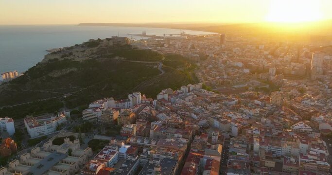 Sunset over the city center and marina of Alicante city, medieval fortess of Santa Barbara. Spain, Costa blanca