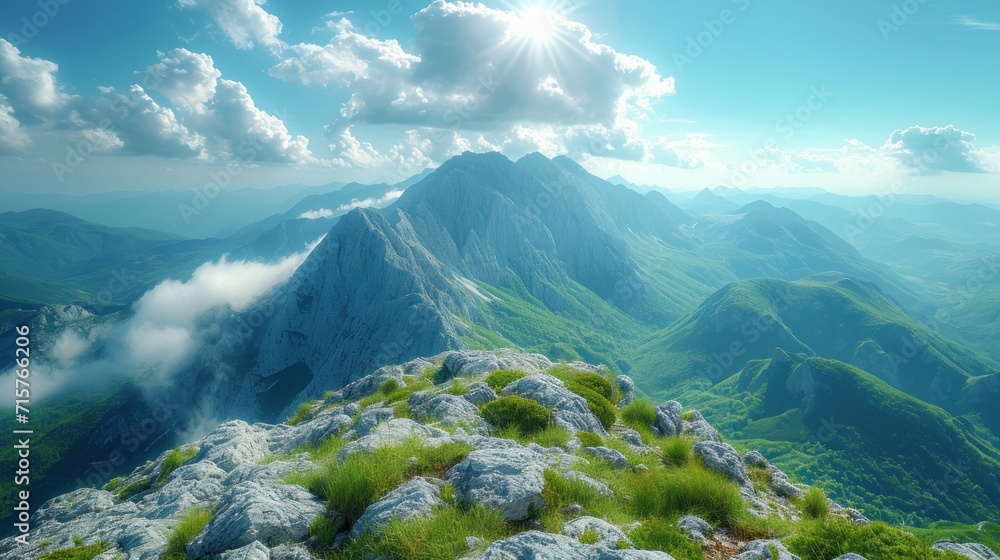 Aufkleber a view of a mountain range from the top of a hill with clouds in the sky and green grass in the fore