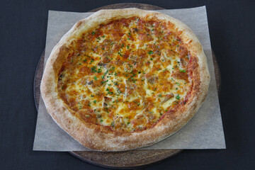 Hot pizza with mozzarella cheese and green basil close-up