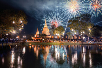 Fireworks celebration of Loy Krathong at Sukhothai Historical Park festival, buddha pagoda stupa in...