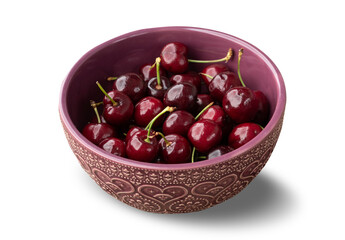 Red cherries in a bowl isolated over white background