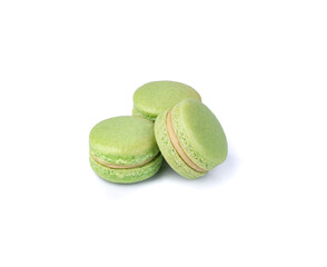 Three pistachio macarons isolated over white background