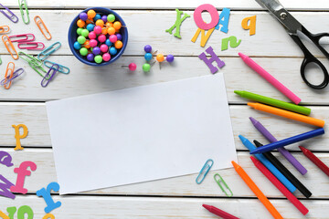 Art craft school supplies background with blank paper for mock up text overlay.