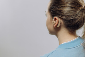 man with a hearing aid on a white background in a shirt without a face