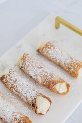 cannoli with powdered sugar