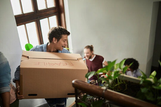Group of young people moving into their new apartment