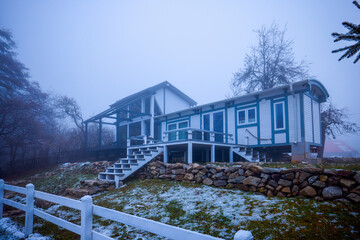modern modular house near a lake during the winter