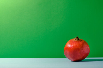 Pomegranate against green and blue colored background
