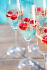 Champagne glasses with raspberry