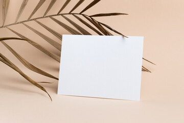 Wedding invitation card mockup with dry palm tree leaf decor