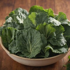Fresh collard greens in a bowl on wooden table.
