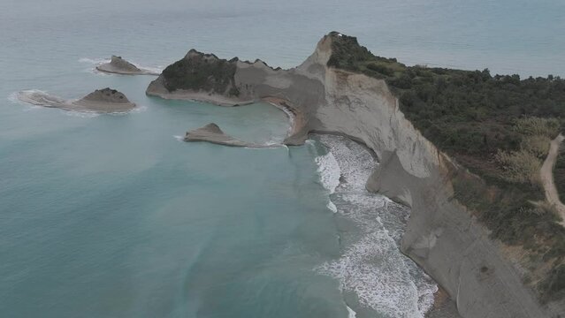 Cape Drastis in Corfu Greece D-log M Drone Shot rocks and blue sea waters 4K