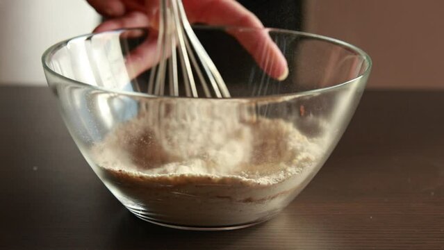 mixing dry ingredients for baking in a glass bowl close-up