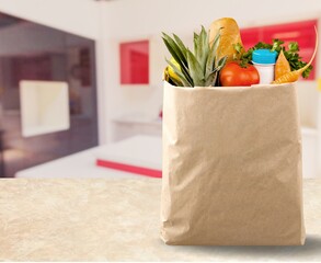 Assorted fresh tasty groceries in a bag, shopping concept