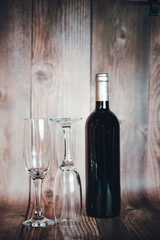 bottle of wine and glass on the wooden background