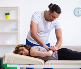 Young woman visiting male doctor physiotherapist