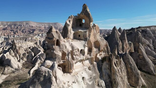 Aerial drone view of the famous Rock Sites of Cappadocia, Turkey. This old settlement is located in the rose red valley in Goreme.