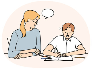 Mother do homework with smiling son