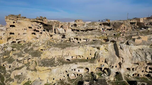 Aerial drone view the old troglodyte settlement of Cavusin, in Cappadocia, Turkey. This location is part of the Goreme National Park and the Rock Sites of Cappadocia inscribed as a Unesco site.