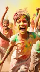 Obraz premium portrait happy smiling young boy celebrating holi festival, colorful face, vibrant powder paint explosion, joyous festival.