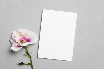 Blank greeting or invite card mockup with flowers, white card mock up with copy space