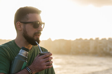 Man drinking chimarrão, mate (an infusion of yerba mate with ho - 715804223