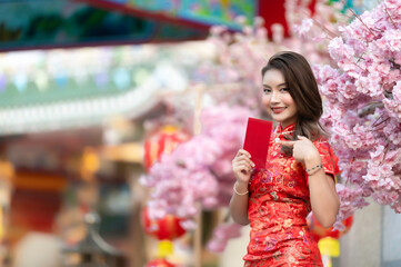Portrait beautiful asian woman in Cheongsam dress,Thailand people,Happy Chinese new year concept,Happy  asian lady in chinese traditional dress