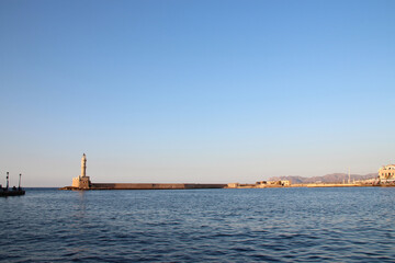 lighthouse, venitian port and mediterranean sea in chania in crete in greece