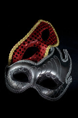 Silver and Red Carnival Masks on Dark Background