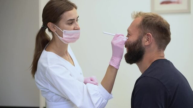 The cosmetologist marks with a pencil the points for beauty injections of botulinum therapy on the face of a man. Concept Plastic surgery and cosmetology for men with copy space