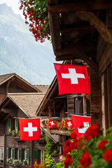 swiss flags with wooden houses - 715814622