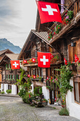 swiss flags with wooden houses - 715814634